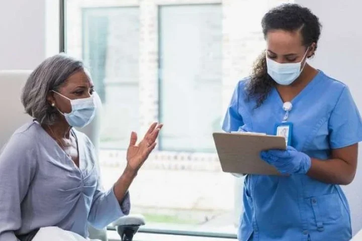 A patient talking to a medical staff