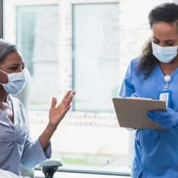 A patient talking to a medical staff